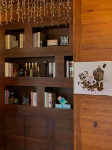 a book shelf with a cup of coffee on it at فندق السلطنة جازان -Alsltanah Jazan Hotel in Jazan