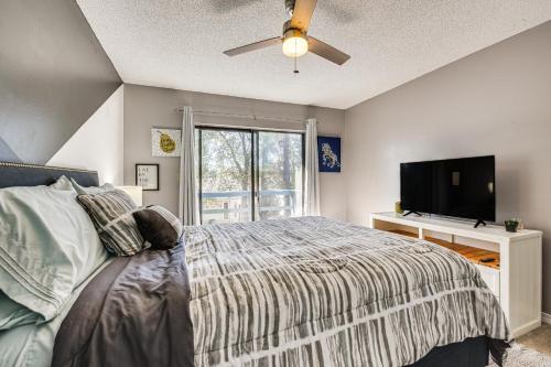 a bedroom with a bed and a flat screen tv at Shalimar Townhome with Screened Porch 6 Mi to Beach in Shalimar