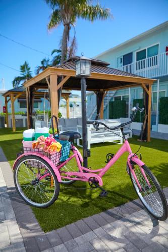 a pink bike parked on the grass near a gazebo at The Pearl Cabana Club in St Pete Beach