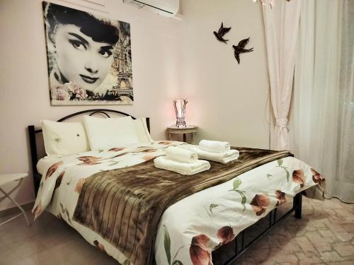 a bedroom with a bed with a picture of a woman at CastleView 2BR Spacious Apartment with City View in Thessaloniki