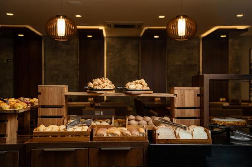 a bakery with many different types of bread and pastries at Exclusive Gramado Hotel & Spa by Gramado Parks in Gramado