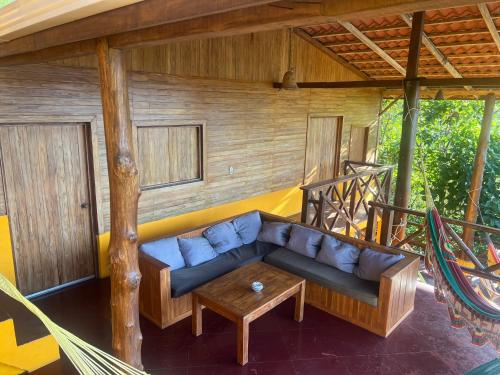 a living room with a blue couch on a porch at Buena Onda Backpackers in San Juan del Sur