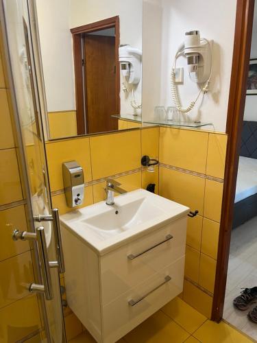 a bathroom with a sink and a mirror at Rooms Barbieri Rovinj in Rovinj