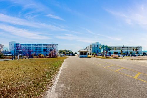 an empty street with buildings in the background and a road at Plantation East #3219 in Gulf Highlands