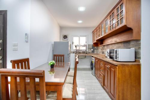 a kitchen with wooden cabinets and a counter top at Lazur Hotel Apartments in Hurghada