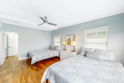 a bedroom with two beds and a ceiling fan at The Pearl Cabana Club in St Pete Beach