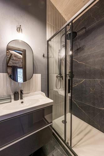 a bathroom with a sink and a shower at Kurpiai - Suites & SPA in Klaipėda