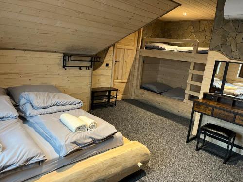 a bedroom with two bunk beds and a desk at Trzy Kopce 