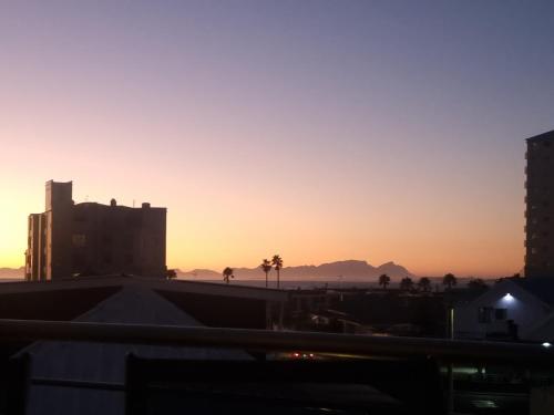 a sunset from the roof of a building at Ocean Escape in Strand