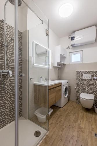 a bathroom with a shower and a toilet and a sink at Apartment Jagoda in Postira