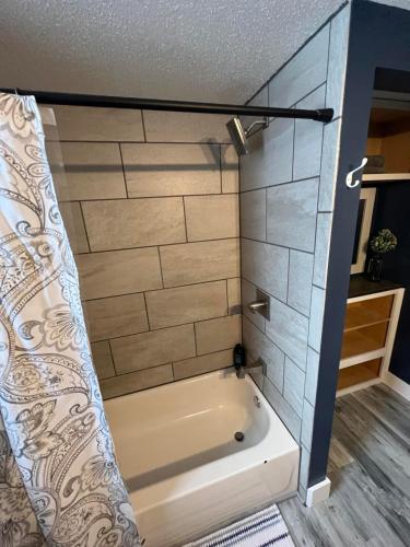 a bathroom with a bath tub in a room at Entire level just off Interstate, free breakfast in Fargo