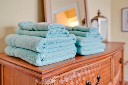 a stack of towels sitting on top of a dresser at Ain`t It The Life Brunswick Vacation Rentals in Ocean Isle Beach