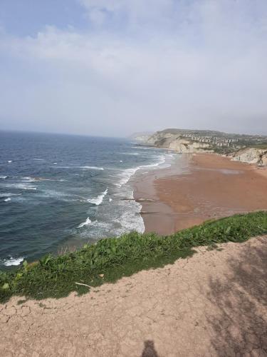 a view of a beach with the ocean at Bilbao, a un paso. in Bilbao