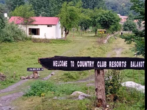 a sign that reads welcome to country club resorts balushima at The Kunhar Beach Cottage At Country Club Balakot in Bālākot