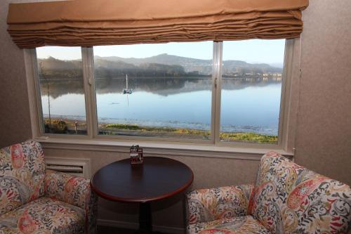 a room with a large window with a view of a lake at Back Bay Inn in San Luis Obispo