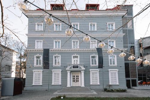 a blue house with lights in front of it at Hotel Twenties Tbilisi - Stay & Dine in Tbilisi City
