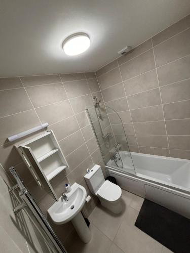 a bathroom with a sink and a toilet and a tub at Maynooth Private Room in a 2 bedroom shared house in Maynooth