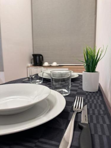 a black and white table with a plate and fork and knife at ROMA HOME in Udine