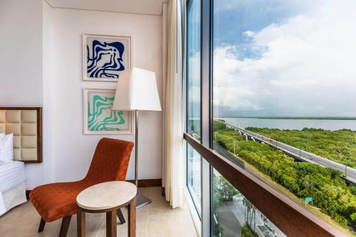 a hotel room with a balcony with a desk and a chair at Holiday Inn Cartagena Morros, an IHG Hotel in Cartagena de Indias