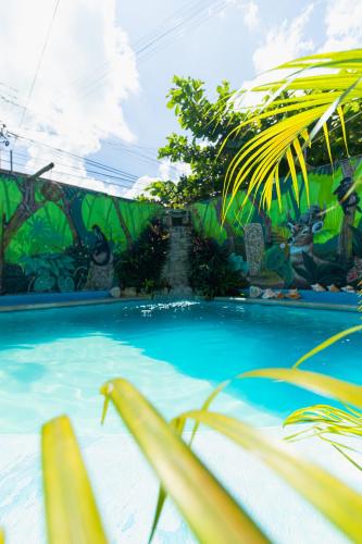 a swimming pool with a painting on the wall at Zayali Bacalar - Guest House in Bacalar