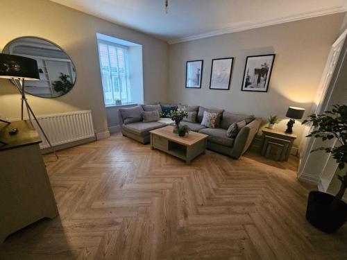 a living room with a couch and a table at HollyJess Hoose in Stranraer