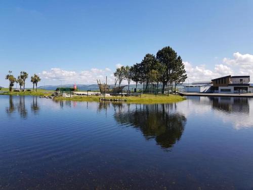 a large body of water with a house and trees at HollyJess Hoose in Stranraer