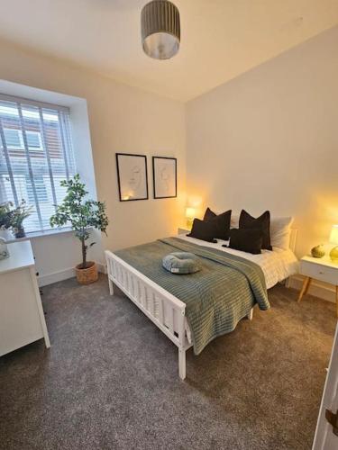 a bedroom with a bed and a window at HollyJess Hoose in Stranraer