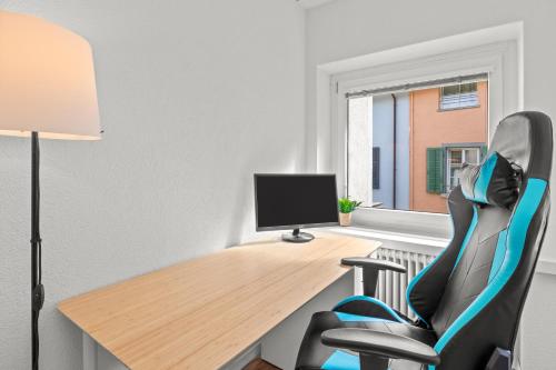 an office with a desk and a computer monitor at Pearlstay - City Center Twin Bed Workplace Washer in Winterthur