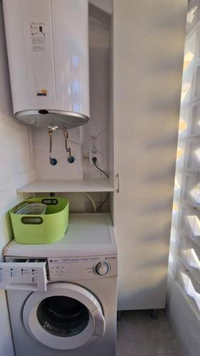 a kitchen with a washing machine and a sink at Stunning sea vistas by the beach in Benicàssim