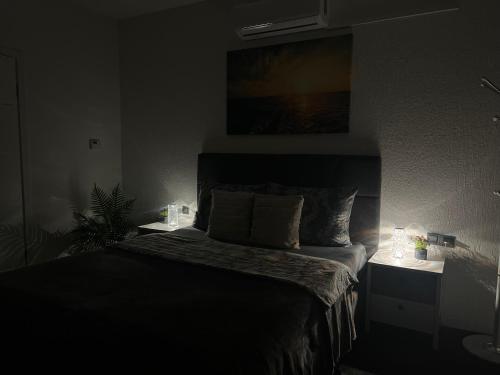 a bedroom with a bed in a dark room at LuxRooms BJELOVAR in Bjelovar