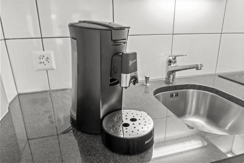 a blender sitting next to a sink in a bathroom at Pearlstay - City Center Twin Bed Workplace Washer in Winterthur