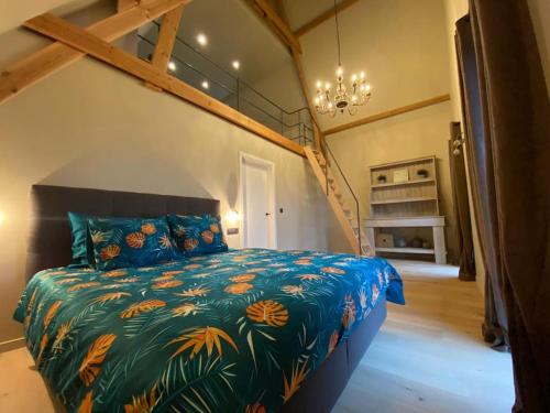 a bedroom with a large bed with a colorful comforter at Vakantiehuis The Nuthouse in Roeselare