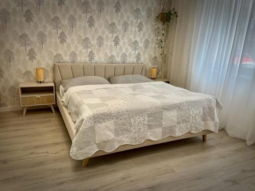 a bedroom with a bed with a comforter on it at Danube12 in Šamorín