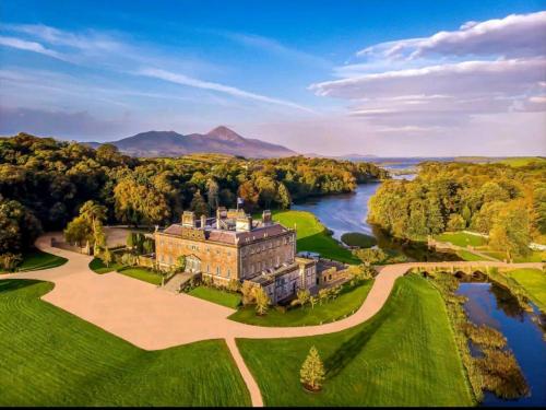 an aerial view of a castle with a river at The Croft Apartment in Westport