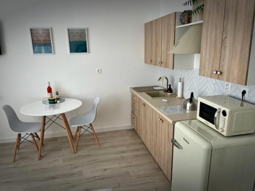 a kitchen with a small table and a microwave at Danube12 in Šamorín