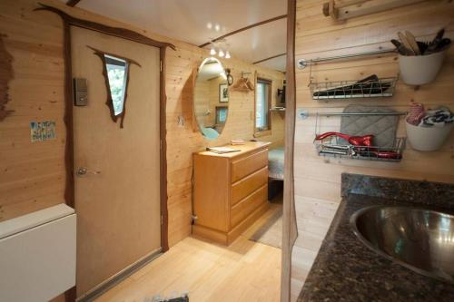 a small bathroom with a sink and a mirror at The Treecycle in Austin