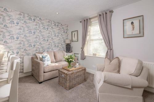 a living room with two chairs and a couch at Brunswick Cottage, Penrith, The Lake District in Penrith