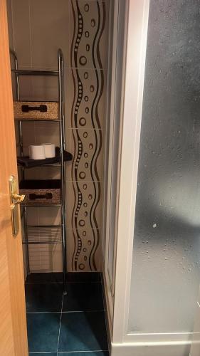 a bathroom door with a spiral pattern on the wall at Apartamento Riglos2 Candanchu in Candanchú