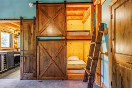 a room with a bunk bed with a ladder in it at Luxury Family Cabin at Summit West in Snoqualmie Pass