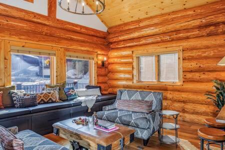 a log cabin living room with a couch and a table at Luxury Family Cabin at Summit West in Snoqualmie Pass