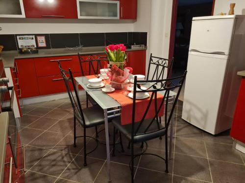 a kitchen with a table with a vase of flowers on it at L occitane in Gimont