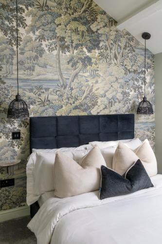 a bedroom with a bed with a wall mural at Gibson Cottage, Penrith, The Lake District in Penrith