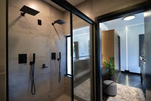 a bathroom with a shower with a glass door at The Altitude Cabana 1374-Black in Urubici
