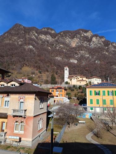 a group of buildings with a mountain in the background at Locanda La Pignatta in Arogno