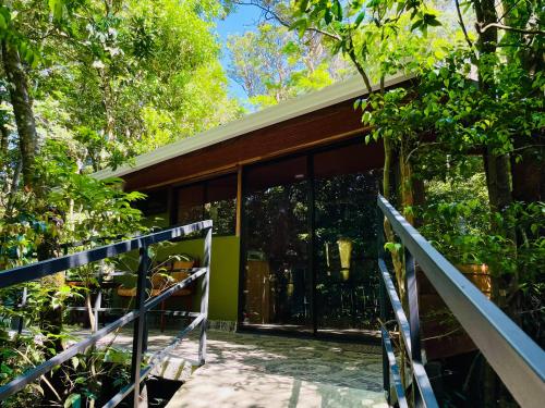 a house in the forest with glass doors at Cabañas La Montaña in Monteverde Costa Rica