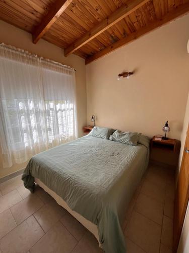 a bedroom with a large bed and a window at Departamento Centro RIOyMAR in Viedma