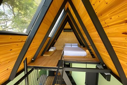 an attic room with a bed and a window at Sitio Sunset Joy in Santa Maria