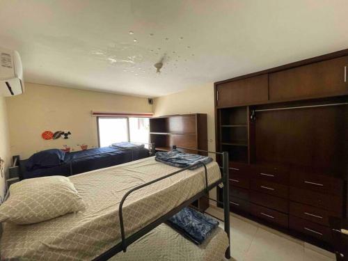 a bedroom with a bed and a dresser at Casa Familiar Diamante in Heroica Alvarado