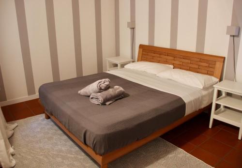 a bed with a stuffed animal laying on it at [Centro storico] deluxe flat in Udine