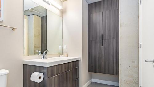a bathroom with a sink and a mirror at Landing - Modern Apartment with Amazing Amenities (ID5631X79) in Milwaukee